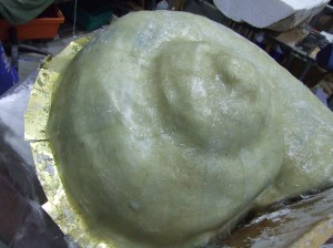 Put a layer of fiber glass in to of your dried silicone. This will keep the silicone mould in place.